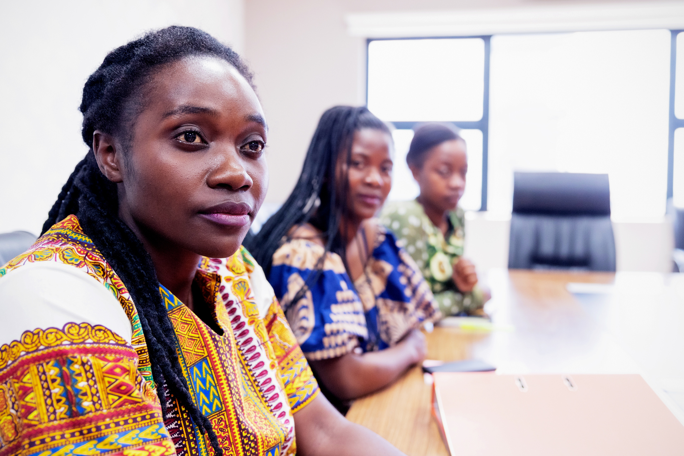 African Women in Traditional Chitenge attending a business meeting